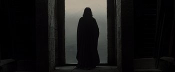Movie still from “Harry Potter and the Deathly Hallows: Part 2” (2011), directed by David Yates – A person standing in front of an open door; Wide shot, Low angle