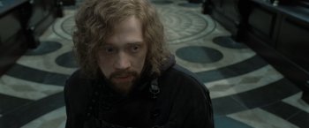 Movie still from “Harry Potter and the Deathly Hallows: Part 2” (2011), directed by David Yates – A man with long hair and a beard is looking at the camera; Close Up shot, High angle
