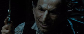 Movie still from “Harry Potter and the Deathly Hallows: Part 2” (2011), directed by David Yates – A man's face in a dark room; Close Up shot, High angle