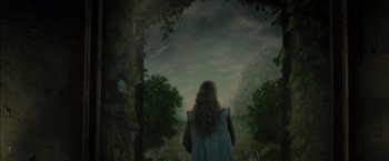 Movie still from “Harry Potter and the Deathly Hallows: Part 2” (2011), directed by David Yates – A woman standing in front of a forest with trees; Medium shot, Low angle