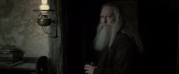 Movie still from “Harry Potter and the Deathly Hallows: Part 2” (2011), directed by David Yates – An old man with long white beard holding a glass; Close Up shot, Over the shoulder angle