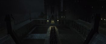 Movie still from “Harry Potter and the Deathly Hallows: Part 2” (2011), directed by David Yates – A group of people standing in front of a building at night; Extreme Wide shot, High angle