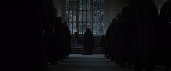 Movie still from “Harry Potter and the Deathly Hallows: Part 2” (2011), directed by David Yates – A group of people standing in front of a large window; Wide shot, Low angle