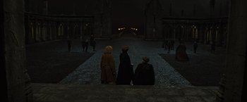 Movie still from “Harry Potter and the Deathly Hallows: Part 2” (2011), directed by David Yates – A group of people standing on the side of a road; Extreme Wide shot, High angle