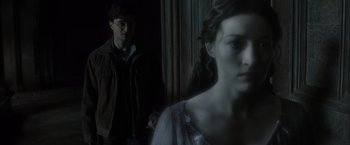 Movie still from “Harry Potter and the Deathly Hallows: Part 2” (2011), directed by David Yates – A man and a woman standing next to each other in front of a window; Close Up shot, Low angle