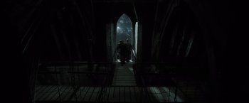 Movie still from “Harry Potter and the Deathly Hallows: Part 2” (2011), directed by David Yates – Two people walking up a flight of stairs; Wide shot, High angle