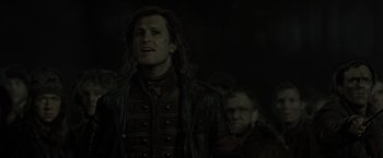 Movie still from “Harry Potter and the Deathly Hallows: Part 2” (2011), directed by David Yates – A man in a leather jacket and a man in a leather jacket; Close Up shot, Over the shoulder angle