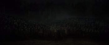 Movie still from “Harry Potter and the Deathly Hallows: Part 2” (2011), directed by David Yates – A large group of people standing in the dark; Extreme Wide shot, High angle