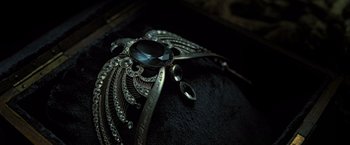 Movie still from “Harry Potter and the Deathly Hallows: Part 2” (2011), directed by David Yates – A black and silver necklace; Extreme Close Up shot, Overhead angle