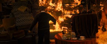 Movie still from “Harry Potter and the Deathly Hallows: Part 2” (2011), directed by David Yates – A man standing in front of an open fire; Wide shot, High angle