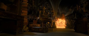 Movie still from “Harry Potter and the Deathly Hallows: Part 2” (2011), directed by David Yates – A fire is burning in the middle of a room; Wide shot, High angle
