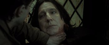 Movie still from “Harry Potter and the Deathly Hallows: Part 2” (2011), directed by David Yates – A woman with a bloody face and hands on her neck; Close Up shot, Overhead angle