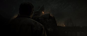 Movie still from “Harry Potter and the Deathly Hallows: Part 2” (2011), directed by David Yates – A man standing in front of a church at night; Extreme Wide shot, Low angle