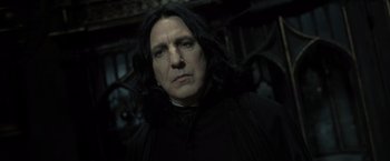 Movie still from “Harry Potter and the Deathly Hallows: Part 2” (2011), directed by David Yates – Severus snape in a dark room looking at the camera; Close Up shot, Low angle
