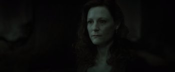 Movie still from “Harry Potter and the Deathly Hallows: Part 2” (2011), directed by David Yates – A woman with long dark hair is looking at the camera; Close Up shot, Low angle