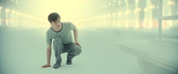 Movie still from “Harry Potter and the Deathly Hallows: Part 2” (2011), directed by David Yates – A man crouching on the ground in front of lights; Wide shot, High angle