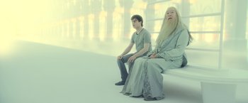 Movie still from “Harry Potter and the Deathly Hallows: Part 2” (2011), directed by David Yates – A man sitting next to an older man on a bench; Wide shot, High angle