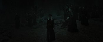 Movie still from “Harry Potter and the Deathly Hallows: Part 2” (2011), directed by David Yates – A group of people standing in a dark field; Wide shot, High angle