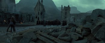 Movie still from “Harry Potter and the Deathly Hallows: Part 2” (2011), directed by David Yates – A group of people standing in front of a building; Extreme Wide shot, High angle