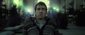 Movie still from “Harry Potter and the Deathly Hallows: Part 2” (2011), directed by David Yates – A young man with a bruised face stares into the camera; Close Up shot, Low angle