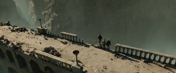 Movie still from “Harry Potter and the Deathly Hallows: Part 2” (2011), directed by David Yates – A group of people standing next to a body of water; Extreme Wide shot, High angle