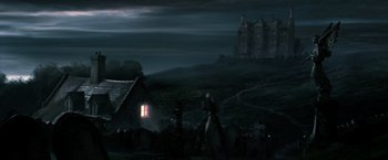 Movie still from “Harry Potter and the Goblet of Fire” (2005), directed by Mike Newell – A group of people standing in front of a house; Extreme Wide shot, Low angle