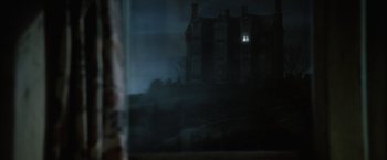 Movie still from “Harry Potter and the Goblet of Fire” (2005), directed by Mike Newell – A window view of a house in the dark; Extreme Wide shot, Over the shoulder angle