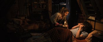 Movie still from “Harry Potter and the Goblet of Fire” (2005), directed by Mike Newell – A woman lighting a candle on a cake; Wide shot, High angle