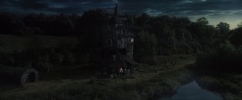 Movie still from “Harry Potter and the Goblet of Fire” (2005), directed by Mike Newell – An oil painting of an old house in the dark; Extreme Wide shot, High angle