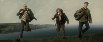 Movie still from “Harry Potter and the Goblet of Fire” (2005), directed by Mike Newell – An old man is walking on a hill by the ocean; Wide shot, Low angle