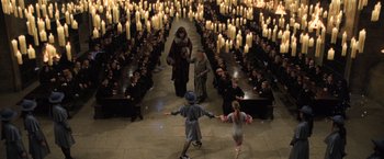 Movie still from “Harry Potter and the Goblet of Fire” (2005), directed by Mike Newell – A group of people standing in front of a room filled with lit candles; Extreme Wide shot, High angle