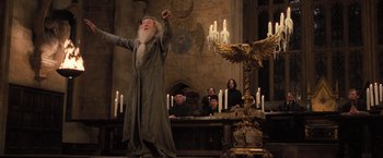 Movie still from “Harry Potter and the Goblet of Fire” (2005), directed by Mike Newell – An old man is standing in front of some candles; Wide shot, Low angle