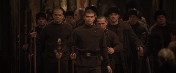 Movie still from “Harry Potter and the Goblet of Fire” (2005), directed by Mike Newell – A group of men standing next to each other; Medium shot, Low angle