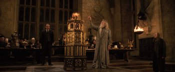 Movie still from “Harry Potter and the Goblet of Fire” (2005), directed by Mike Newell – An old man is standing next to a burning candle; Wide shot, Low angle