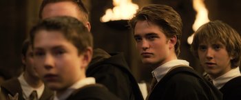 Movie still from “Harry Potter and the Goblet of Fire” (2005), directed by Mike Newell – A person wearing a suit and tie; Close Up shot, Over the shoulder angle