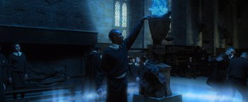 Movie still from “Harry Potter and the Goblet of Fire” (2005), directed by Mike Newell – A man is lighting a candle in a room; Medium shot, Low angle