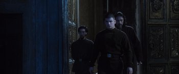 Movie still from “Harry Potter and the Goblet of Fire” (2005), directed by Mike Newell – A group of men standing next to each other in a room; Medium shot, Low angle