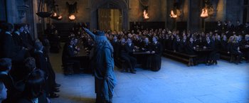 Movie still from “Harry Potter and the Goblet of Fire” (2005), directed by Mike Newell – A group of people sitting in front of an audience; Wide shot, High angle