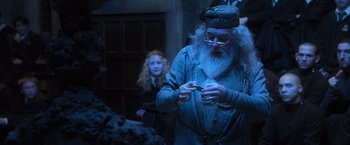 Movie still from “Harry Potter and the Goblet of Fire” (2005), directed by Mike Newell – A man with a long white beard holding a cigarette; Medium shot, Low angle