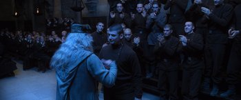 Movie still from “Harry Potter and the Goblet of Fire” (2005), directed by Mike Newell – A group of people standing in front of each other in a room; Wide shot, Over the shoulder angle