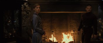 Movie still from “Harry Potter and the Goblet of Fire” (2005), directed by Mike Newell – A woman standing in front of a fire place; Medium shot, Over the shoulder angle