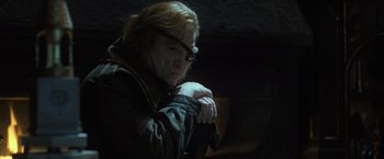 Movie still from “Harry Potter and the Goblet of Fire” (2005), directed by Mike Newell – An older woman with red hair and glasses is leaning on her arm; Close Up shot, Over the shoulder angle