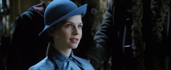 Movie still from “Harry Potter and the Goblet of Fire” (2005), directed by Mike Newell – A woman wearing a blue hat and a blue dress; Close Up shot, Over the shoulder angle