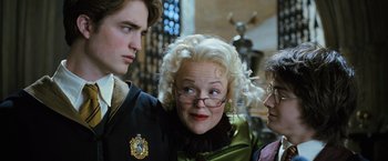 Movie still from “Harry Potter and the Goblet of Fire” (2005), directed by Mike Newell – A group of people standing next to each other in a room; Close Up shot, Over the shoulder angle