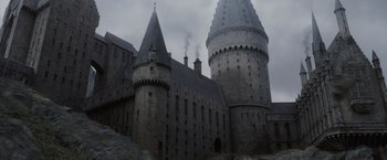 Movie still from “Harry Potter and the Goblet of Fire” (2005), directed by Mike Newell – An old building with a tower and a castle like structure in the background; Extreme Wide shot, High angle