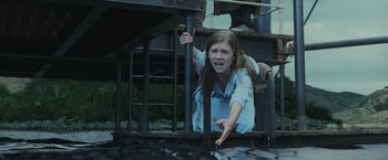 Movie still from “Harry Potter and the Goblet of Fire” (2005), directed by Mike Newell – A young girl is sitting on a railing; Medium shot, Low angle