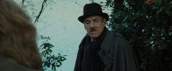Movie still from “Harry Potter and the Goblet of Fire” (2005), directed by Mike Newell – An older man wearing a black hat and a black coat; Close Up shot, Low angle