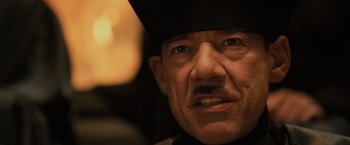 Movie still from “Harry Potter and the Goblet of Fire” (2005), directed by Mike Newell – An older man wearing a black hat and a mustache; Close Up shot, Low angle