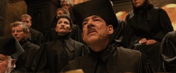 Movie still from “Harry Potter and the Goblet of Fire” (2005), directed by Mike Newell – A group of people in black suits and black hats; Medium shot, Low angle