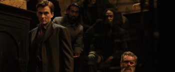Movie still from “Harry Potter and the Goblet of Fire” (2005), directed by Mike Newell – A group of people sitting in a room; Medium shot, Over the shoulder angle